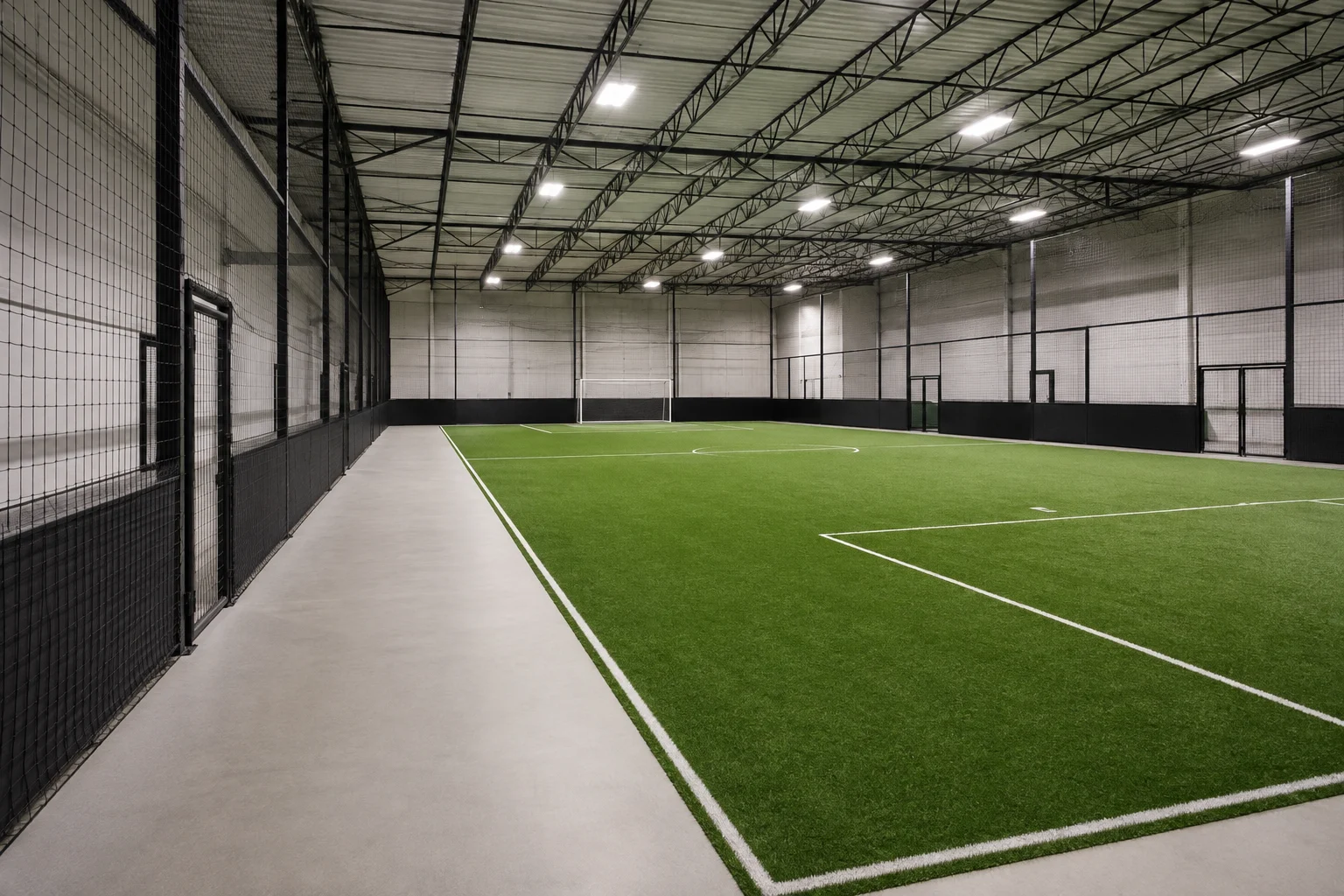 Indoor soccer venue with turf, safety run-off and side netting