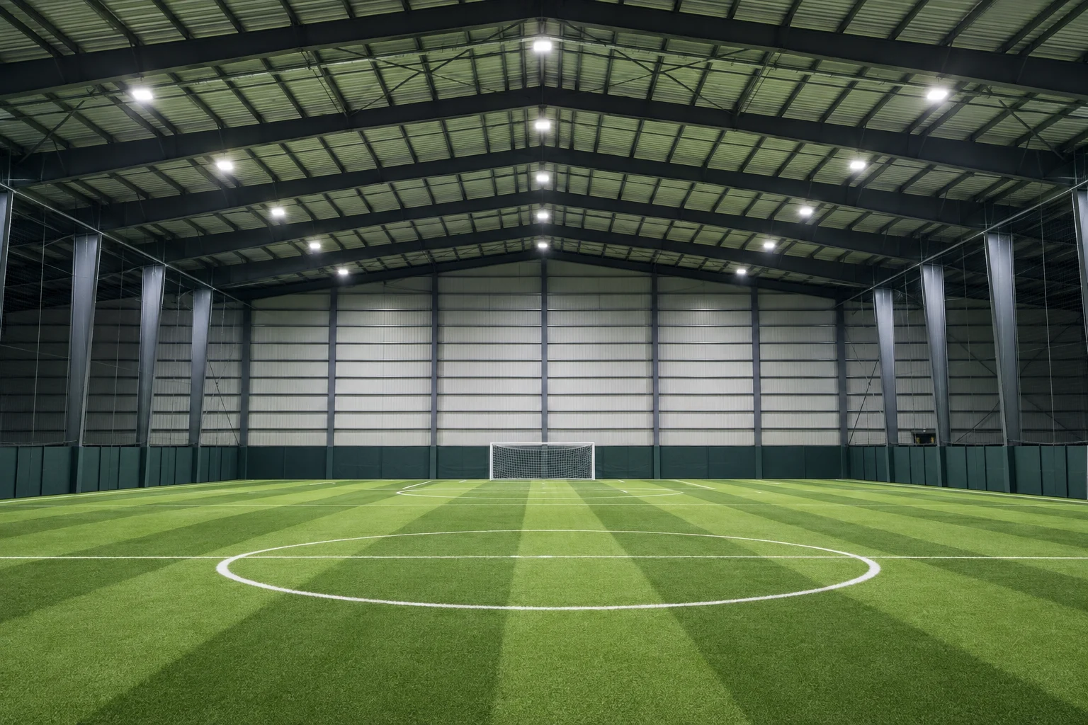 Even overhead lighting above an indoor soccer pitch