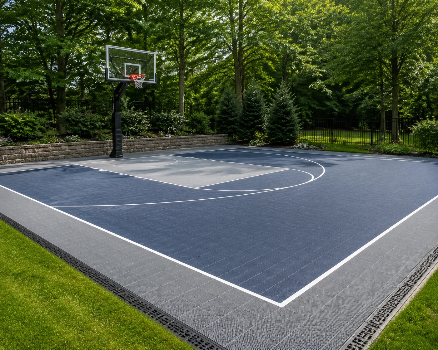 Outdoor basketball court with modular surface tiles and drainage edge