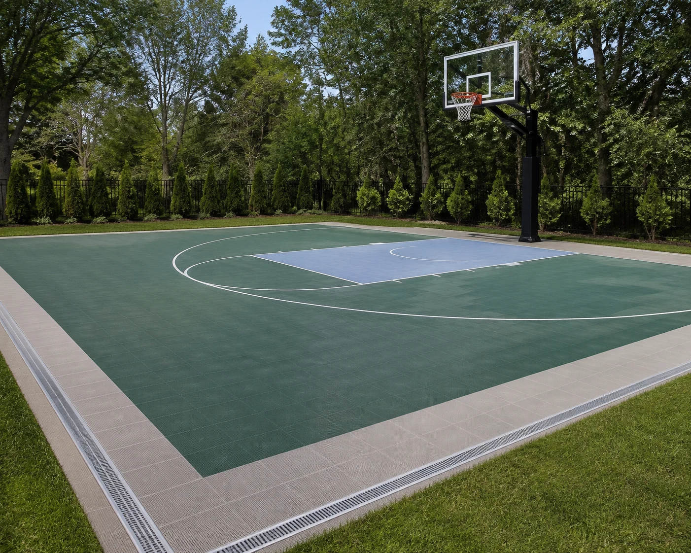 Outdoor basketball court with modular surface tiles and drainage edge