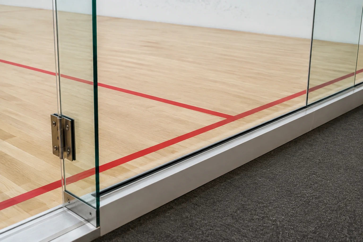 Squash court glass wall and floor junction detail