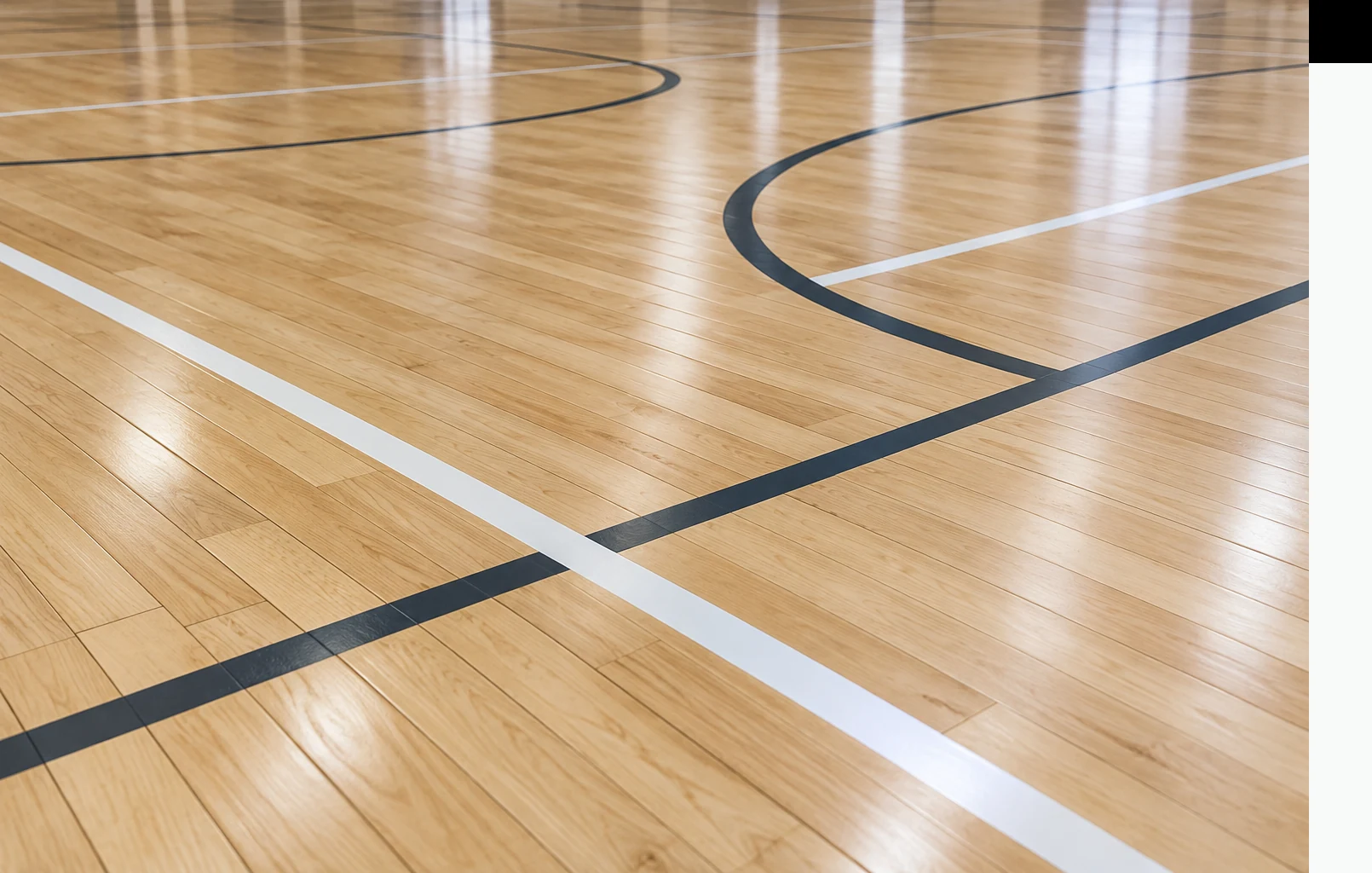 Close view of hardwood sports flooring and court-line intersections