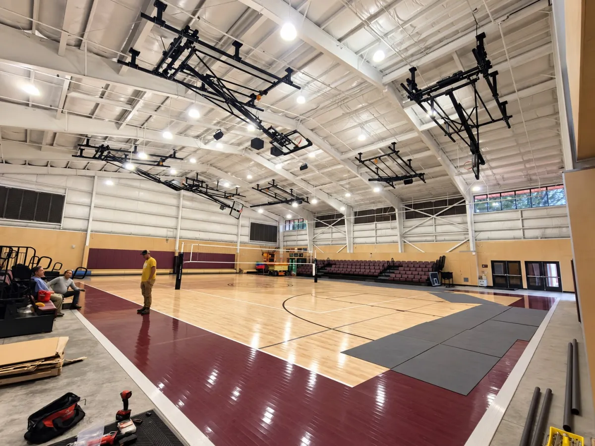 Wood-floor gym in Hawaii with ceiling-suspended basketball systems