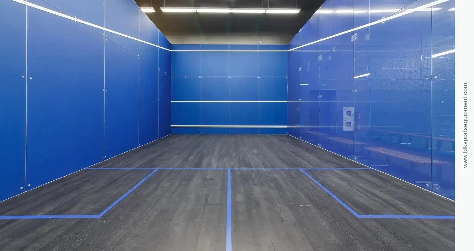 Wall, door and floor details meet at the finished court Interior squash court with finished walls and wood-look flooring