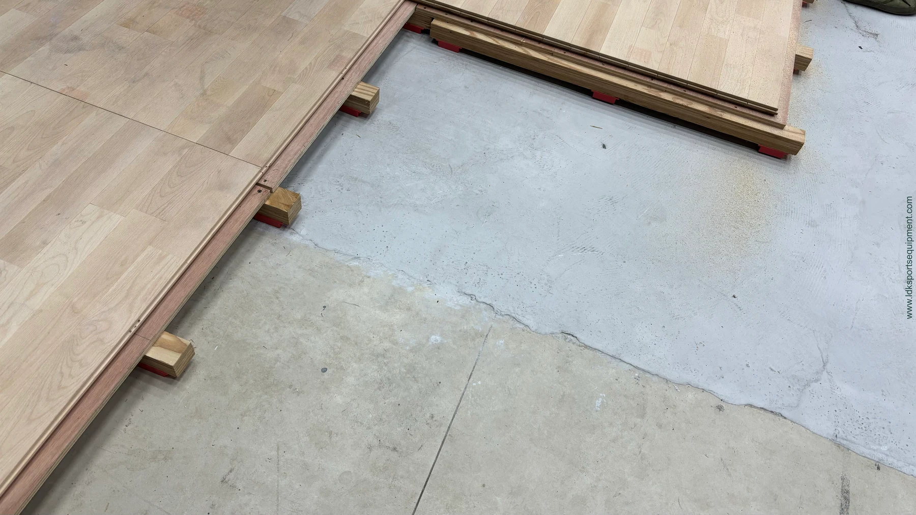 Rendering of squash court floor panels and support components at an assembly edge