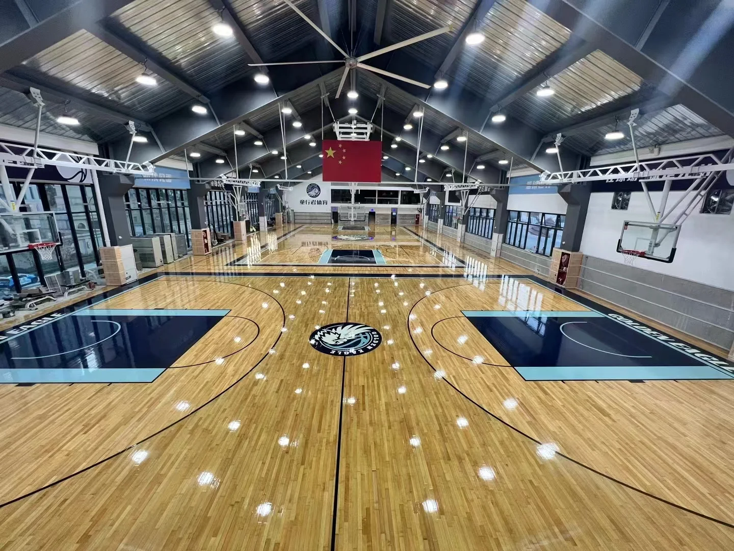 Hover to inspect venue details Indoor basketball court with hardwood sports flooring, shown as an application reference